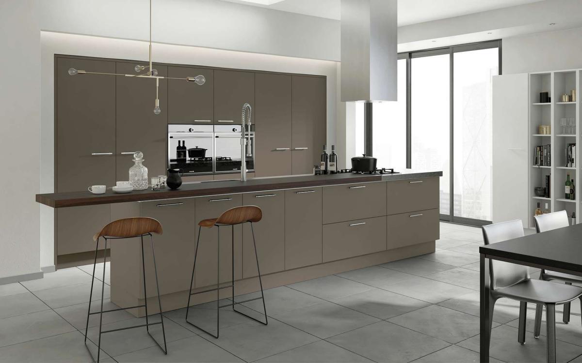 Smooth painted slab door kitchen with long island feature and recessed tall units in Velluto Stone Grey style